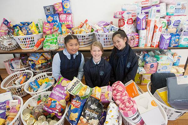 Our Lady of Mount Carmel Catholic Primary School Mt Pritchard Bonnyrigg - students standing next to food drive